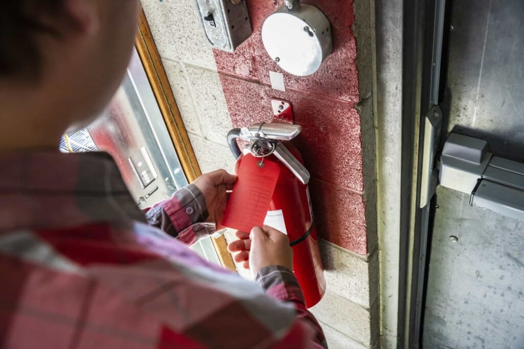 Fire safety inspection checklist with engineer reviewing documents